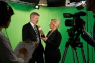 Female talent presenter Interviewing In St Louis Video Television Studio With Crew In Foreground